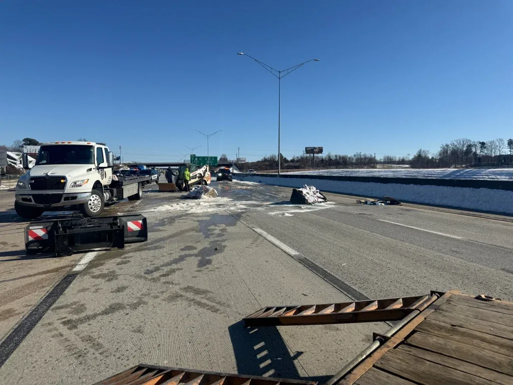Fonvilletreeservice crew assists with highway accident debris cleanup on snow-covered interstate with tow trucks and emergency response vehicles in NC