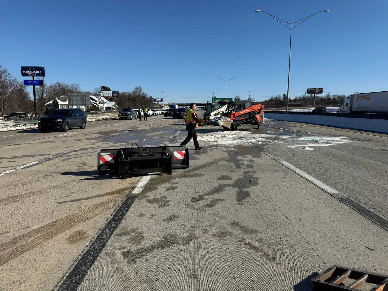Crew clearing ice and snow from a roadway