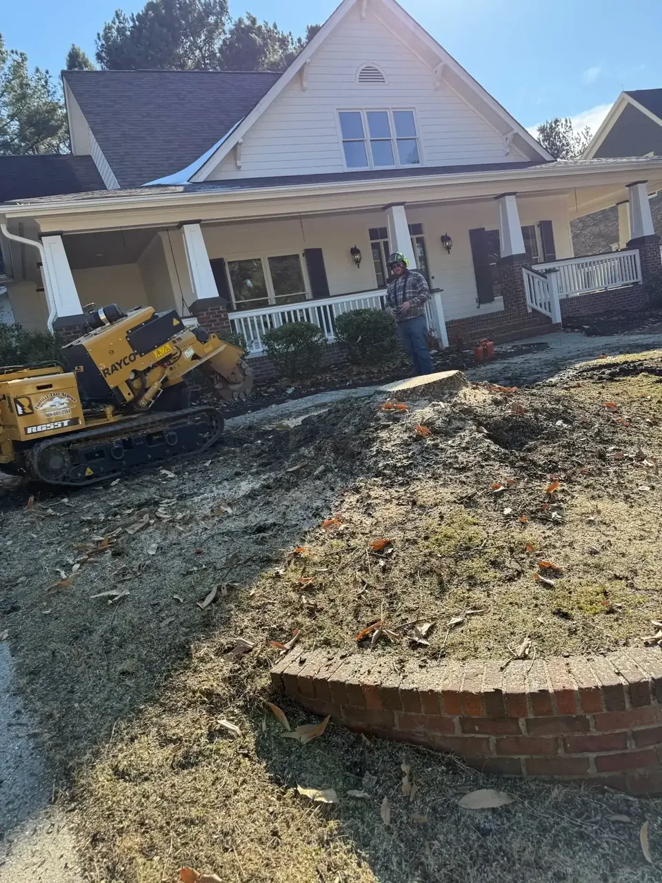 Stump grinder finishing a stump in a front yard Stump grinder finishing a stump in a front yard